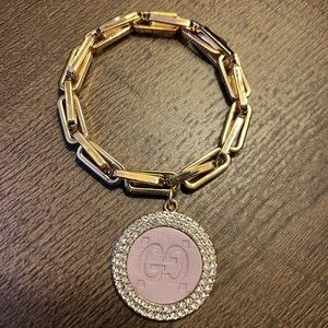 Luxurious Gold Bracelet with Pink Emblem